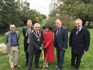 Sir David plants donated tree in local park 